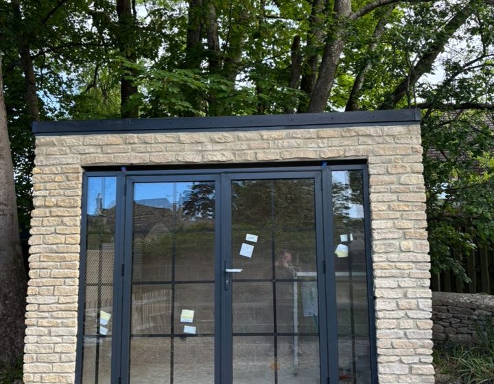 Garden garage with glazed blue-framed doors